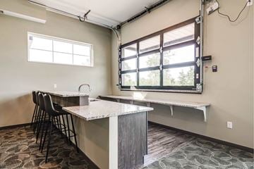 Coon Rapids apartment for rent - A kitchen area with a counter and chairs.