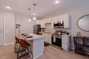 Cambridge apartment for rent - a kitchen with white cabinets and a white counter top and a black and white