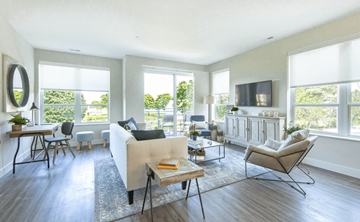 Kenosha apartment for rent - A living room with a white couch and a wooden coffee table.