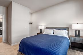 Monona apartment for rent - A bedroom with a large bed and two lamps on the side tables.