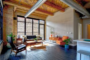 Milwaukee apartment for rent - A living room with a wooden floor and a large window.