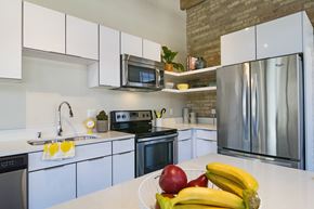 Milwaukee apartment for rent - A kitchen with a white counter top and a bowl of fruit on it.
