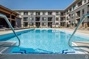 Madison apartment for rent - a swimming pool with an apartment building in the background at Two Points Crossing, Verona, WI