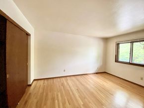 Greendale townhouse for rent - A room with wooden flooring and a window at Root River Apartments, Greendale, Wisconsin