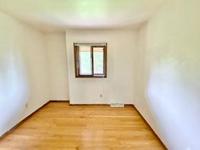 Greendale townhouse for rent - A room with a window and wooden flooring at Root River Apartments, Greendale, WI