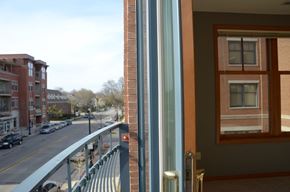 Shorewood apartment for rent - A view of a street from a window with a balcony at Cornerstone & Ravenna* Apartments, Shorewood, WI