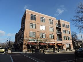 Shorewood apartment for rent - A large brick building with a coffee shop on the ground floor at Cornerstone & Ravenna* Apartments, Shorewood, WI, 53211