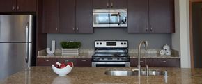 Shorewood apartment for rent - A kitchen with a stainless steel refrigerator and a stove top oven at Cornerstone & Ravenna* Apartments, Wisconsin