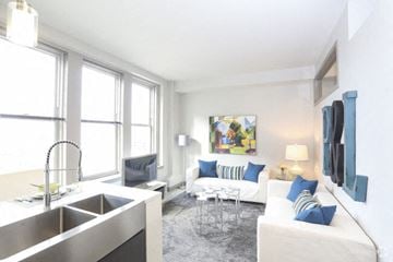 Kansas City apartment for rent - A modern kitchen with a white couch and a painting on the wall.