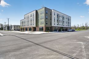 Detroit townhouse for rent - A large building with a parking lot in front of it.