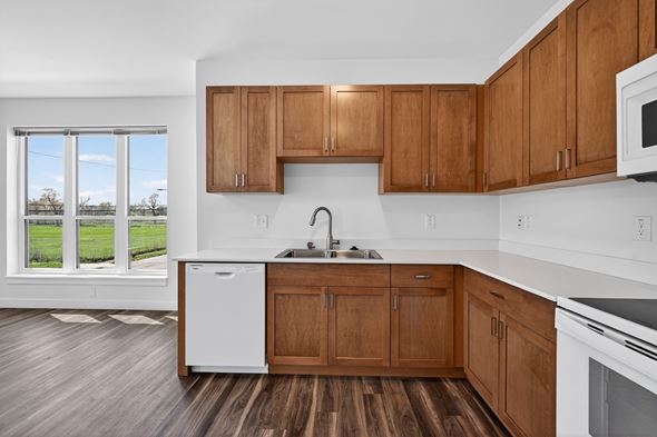 Detroit townhouse for rent - A kitchen with wooden cabinets and white appliances.