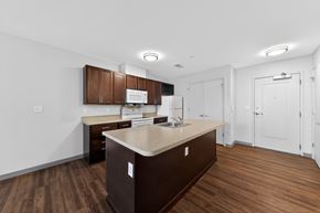 Cincinnati apartment for rent - A kitchen with brown cabinets and a countertop.