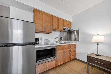 Dorchester apartment for rent - A modern kitchen with wooden cabinets and stainless steel appliances.