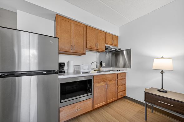 Dorchester apartment for rent - A modern kitchen with wooden cabinets and stainless steel appliances.