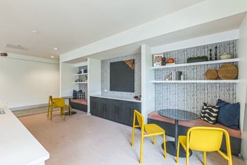 Washington apartment for rent - A living room with a yellow chair and a grey table.