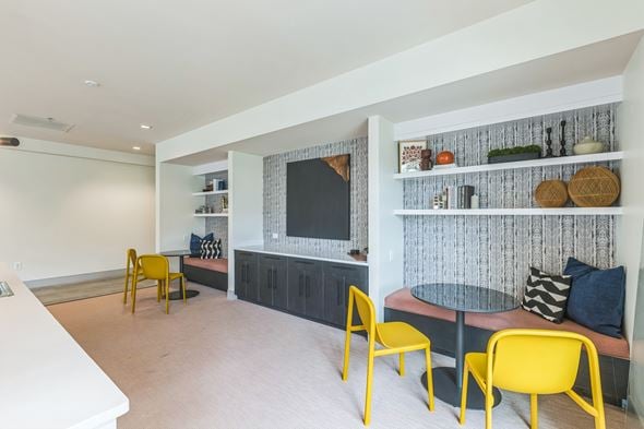 Washington apartment for rent - A living room with a yellow chair and a grey table.