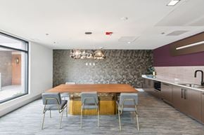 Washington apartment for rent - A modern dining room with a wooden table and grey chairs.