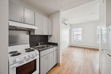 Worcester apartment for rent - A kitchen with white appliances and wooden floors.