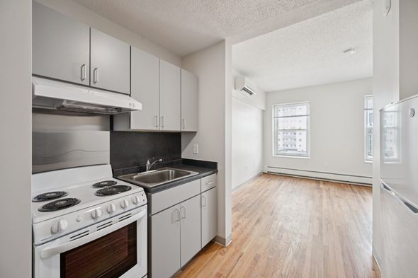 Worcester apartment for rent - A kitchen with white appliances and wooden floors.