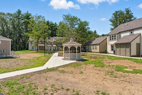 Stow apartment for rent - A gazebo is in the middle of a playground surrounded by houses.