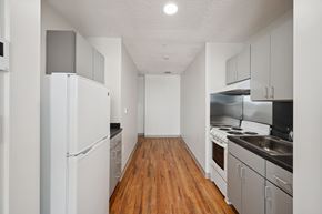 Worcester apartment for rent - A kitchen with white appliances and wooden floors.