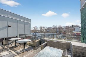 Boston apartment for rent - A rooftop patio with a hot tub and seating area.