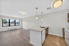 New Brunswick apartment for rent - A kitchen with a white counter and wooden floors.