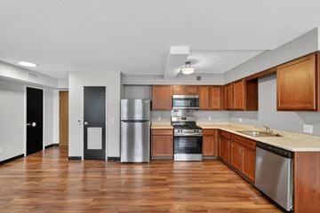 Cleveland apartment for rent - A kitchen with wooden cabinets and stainless steel appliances.