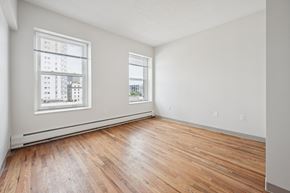 Worcester apartment for rent - A room with wooden floors and two windows.