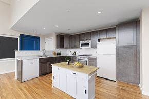 Pittsburgh apartment for rent - a kitchen with white cabinets and white appliances and a wooden counter top