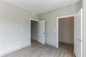 Cleveland townhouse for rent - an empty room with a door to a closet and a hard wood floor