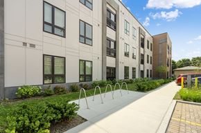 Chicago apartment for rent - a large white building with a sidewalk in front of it