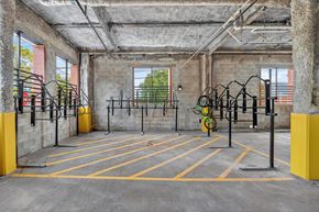 New Brunswick apartment for rent - A gym with yellow barriers and exercise equipment.
