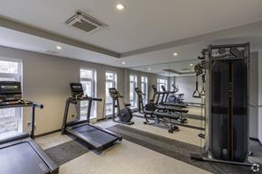 Boston apartment for rent - a gym with cardio equipment and windows in a building