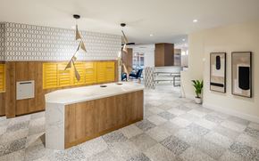 Boston apartment for rent - a large kitchen with yellow cabinets and a white counter top