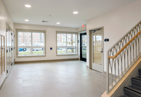 Northampton apartment for rent - A hallway with a staircase on the right and a door at the end.
