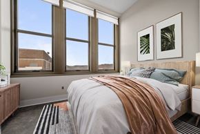 Pittsburgh apartment for rent - a bedroom with a bed and three windows