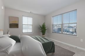 Baltimore apartment for rent - A bedroom with two beds and a large window.