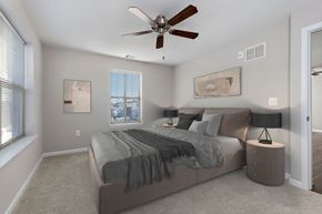 Baltimore apartment for rent - A bedroom with a bed, nightstands, and a ceiling fan.