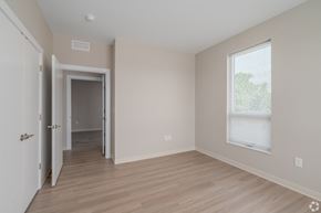 Cleveland apartment for rent - an empty bedroom with hardwood flooring and a large window