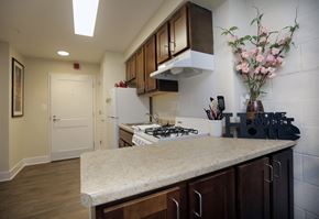Baltimore apartment for rent - A kitchen with a white stove top oven and a white refrigerator.