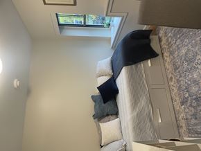 Amherst apartment for rent - A room with a window and a couch with pillows.