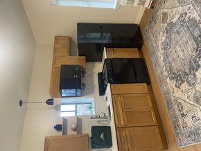 Amherst apartment for rent - A kitchen area with wooden cabinets and a rug on the floor.