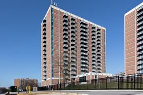 Baltimore apartment for rent - A tall red brick building with balconies on the side.