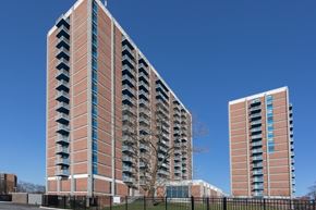 Baltimore apartment for rent - A tall red brick building with balconies on the side.