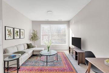 Cleveland apartment for rent - a living room with a white couch and a tv