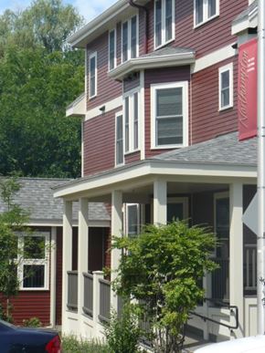Florence apartment for rent - A red house with a white porch and a car parked in front.