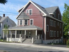 Florence apartment for rent - A red two-story house with a porch and a covered entrance.