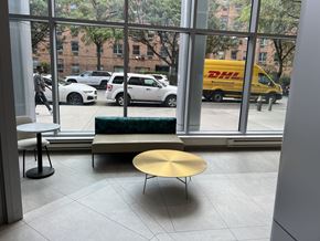 Bronx apartment for rent - A view of a street through a window with a DHL van on it.