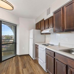 Baltimore apartment for rent - A kitchen with wooden cabinets and a white fridge.